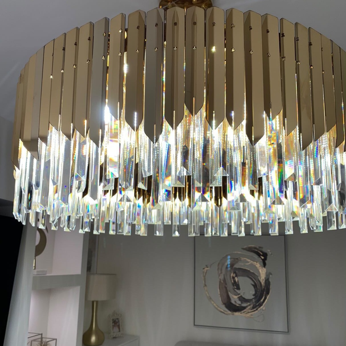 Close view of VORELLI Manhattan circular chandelier showing layered crystal bars and halo ring frame