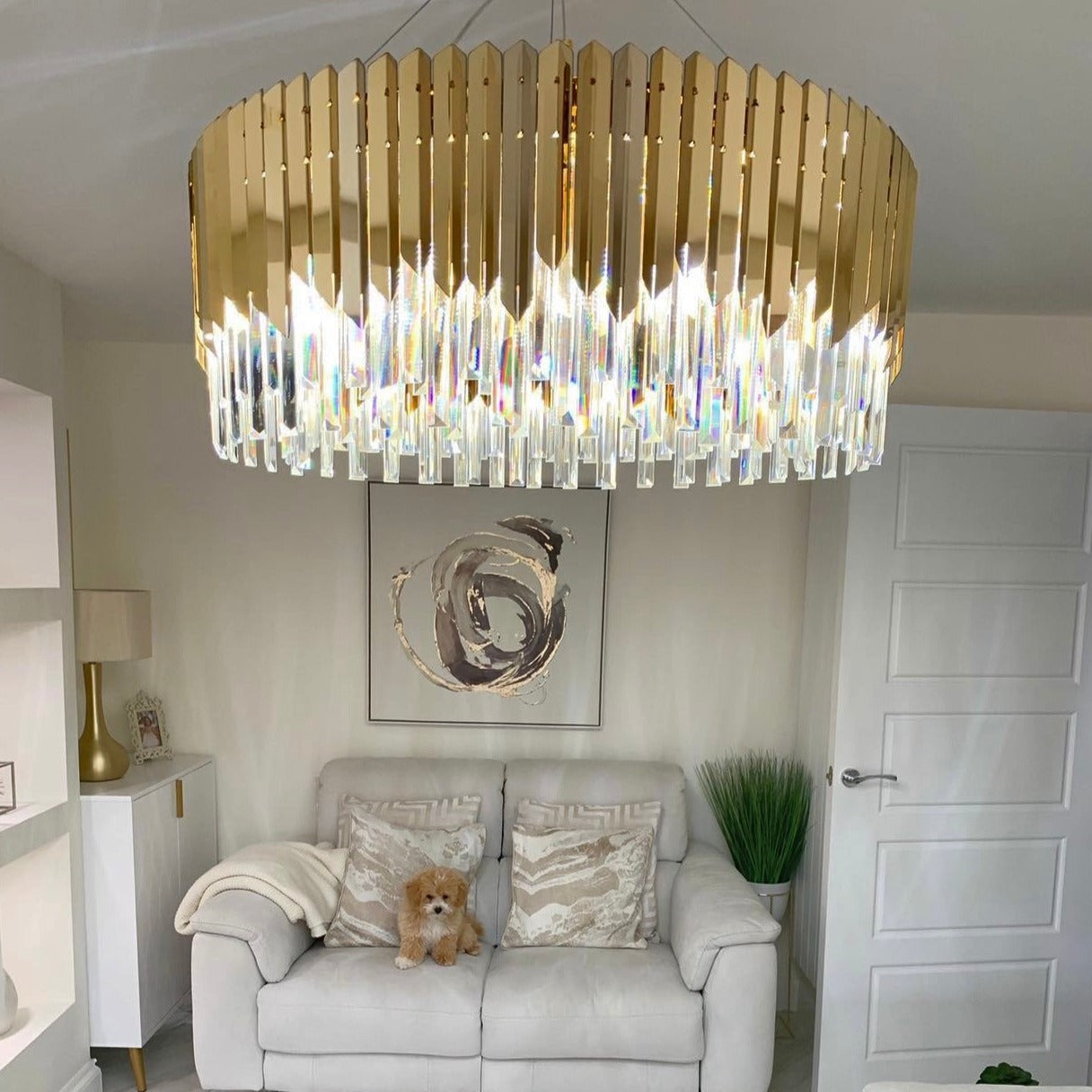 VORELLI Manhattan circular crystal chandelier creating elegant ambient lighting in a living room