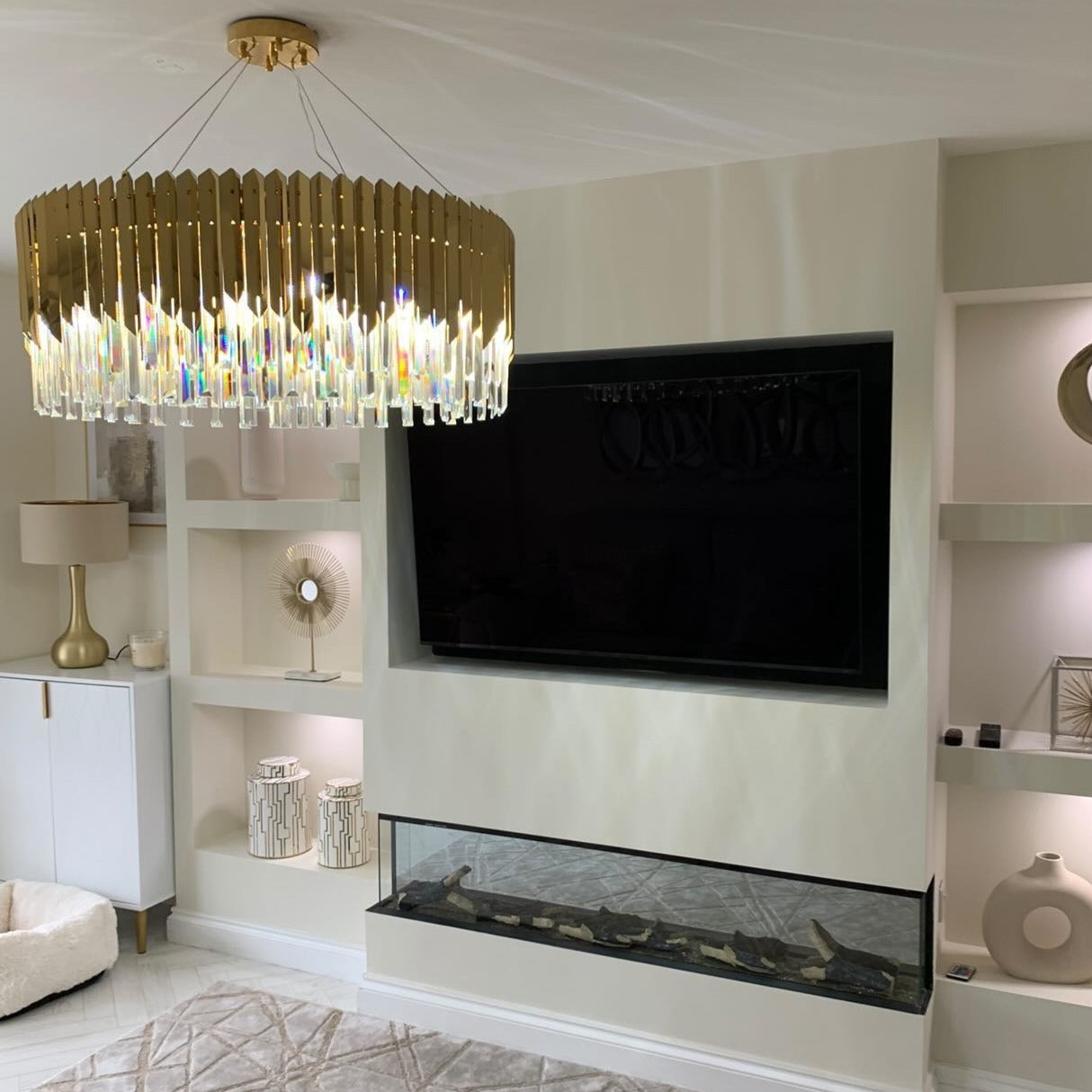 VORELLI Manhattan circular chandelier with crystal bars enhancing a modern luxury lounge