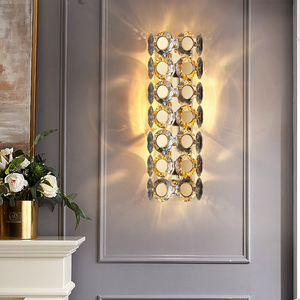 VORELLI Manzoni wall light with diamond cut crystal discs surrounding a titanium gold stainless steel frame in a luxury interior