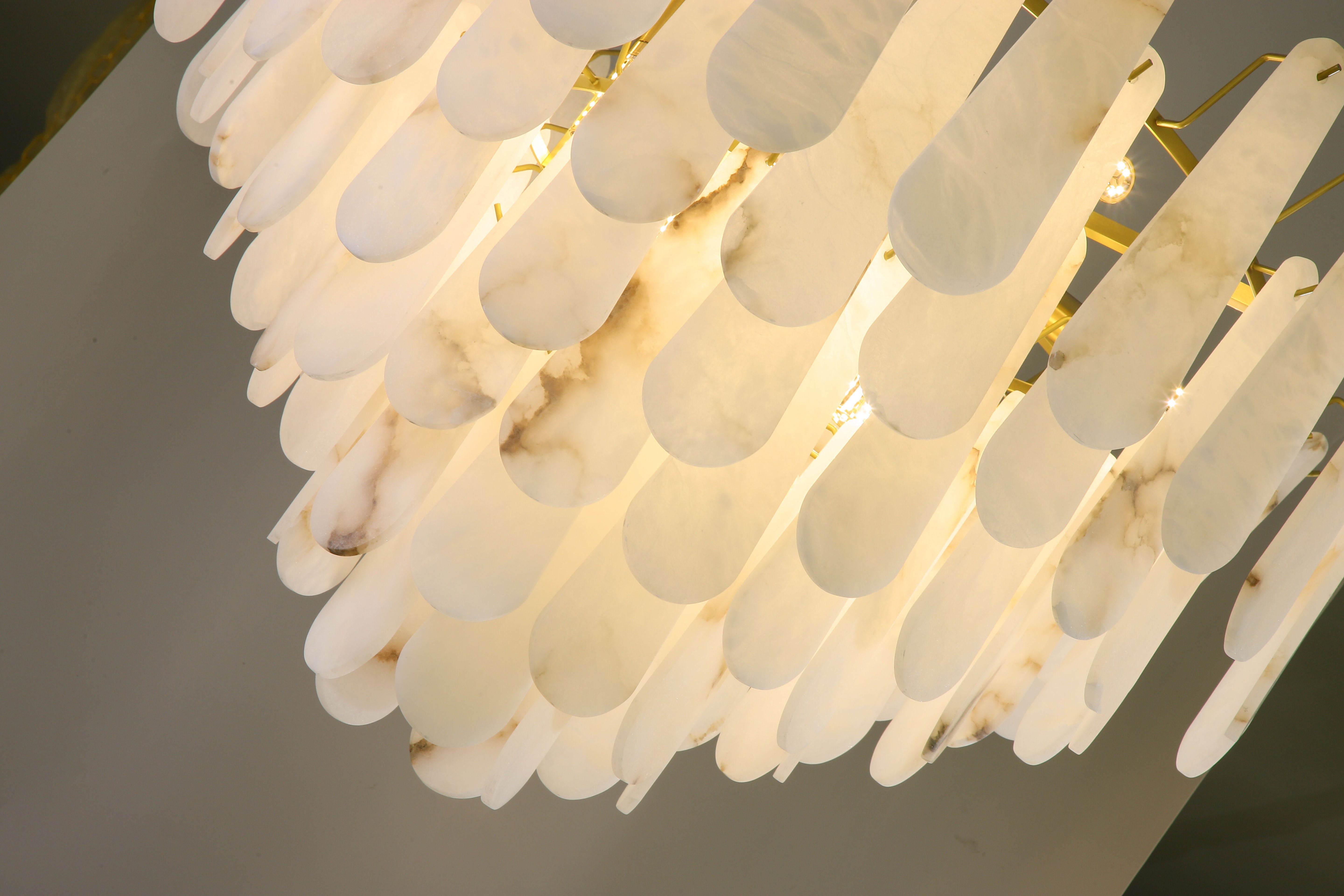 Layered natural marble drops arranged in a circular formation on the VORELLI Maretto chandelier