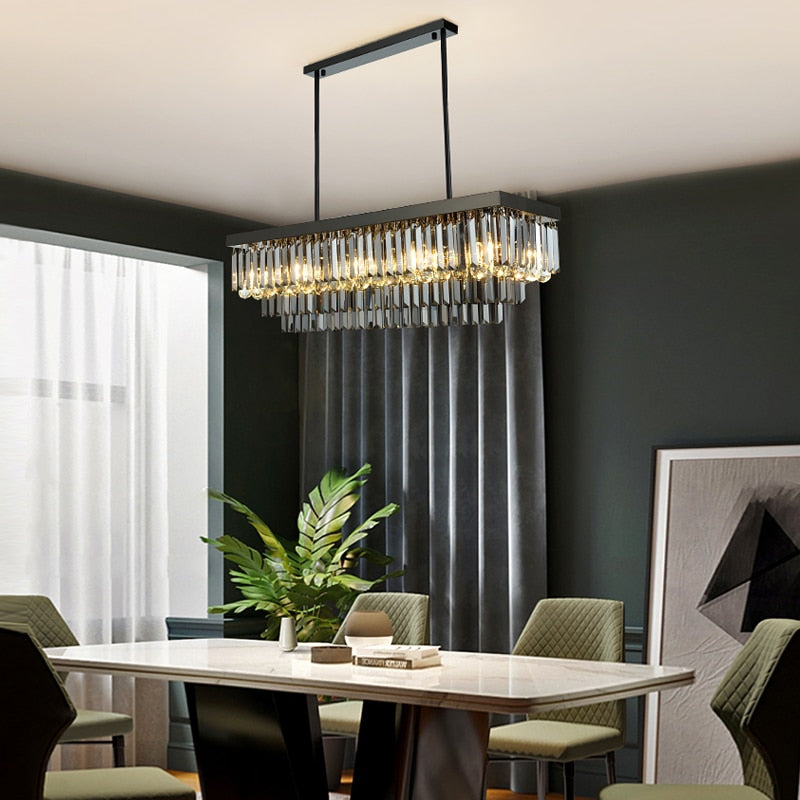 VORELLI Margoux rectangular chandelier with crystal bars and spheres suspended above a modern dining table creating refined ambient lighting