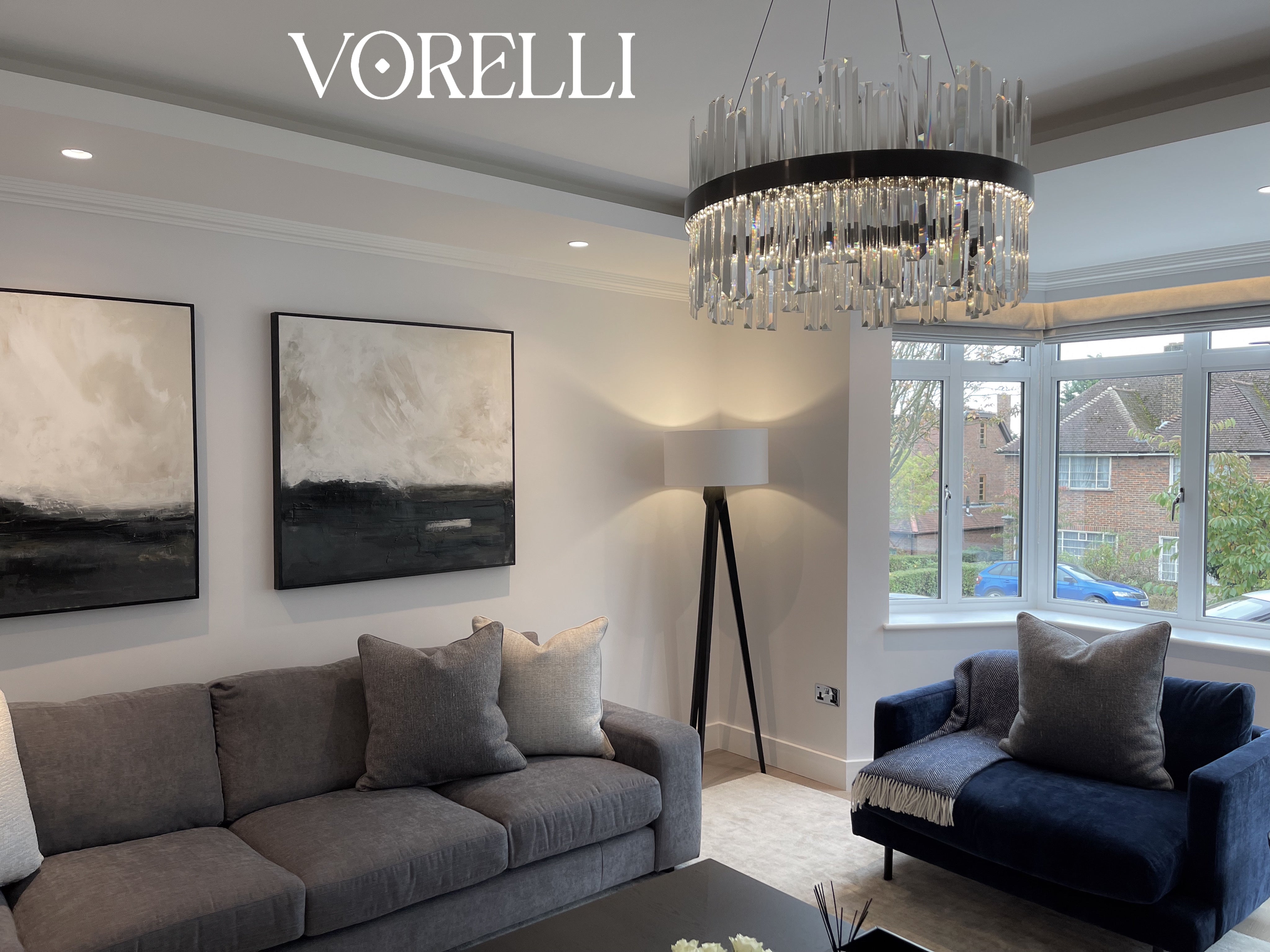 Luxury VORELLI Medina circular chandelier illuminating an elegant living room with contemporary crystal ring lighting design