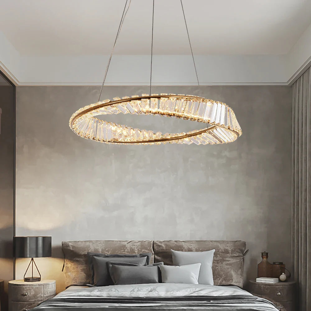 VORELLI Melia circular chandelier with twisted crystal bar ring design suspended above a modern luxury bedroom