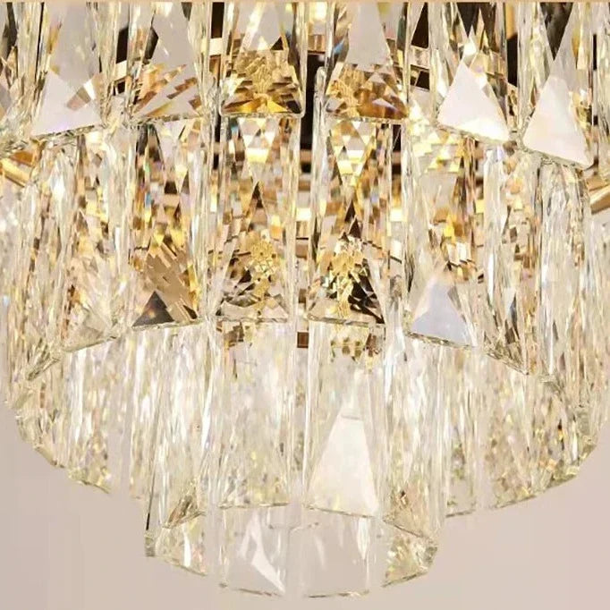 Illuminated VORELLI Milltimber Pendant Light showing layered crystal drops and refined cylindrical frame