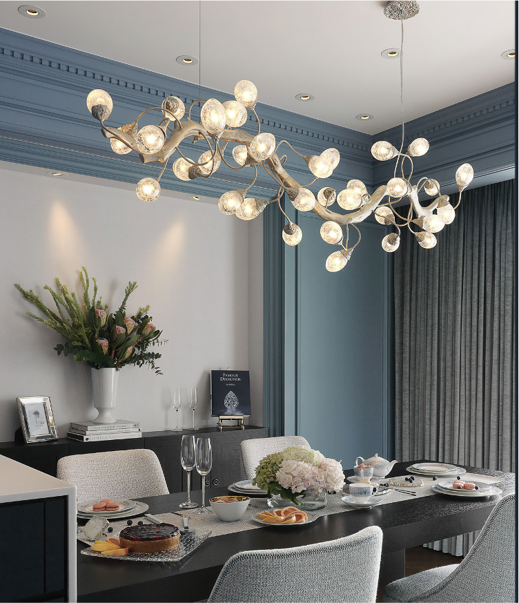 Rectangular luxury chandelier suspended above dining table in refined interior setting