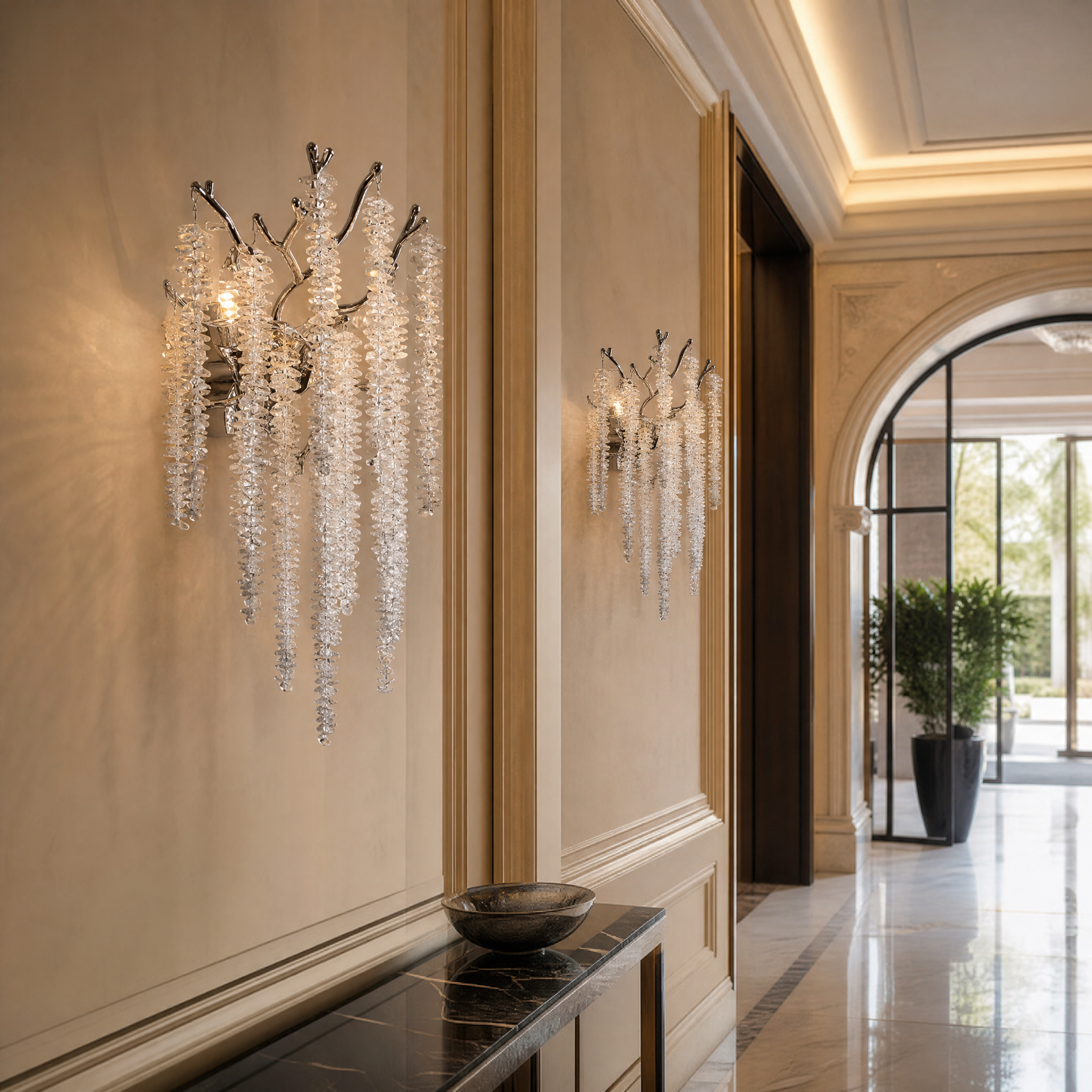 A pair of VORELLI Wisteria crystal wall sconces creating a sophisticated, grand ambiance in a luxury boutique hotel lobby hallway.