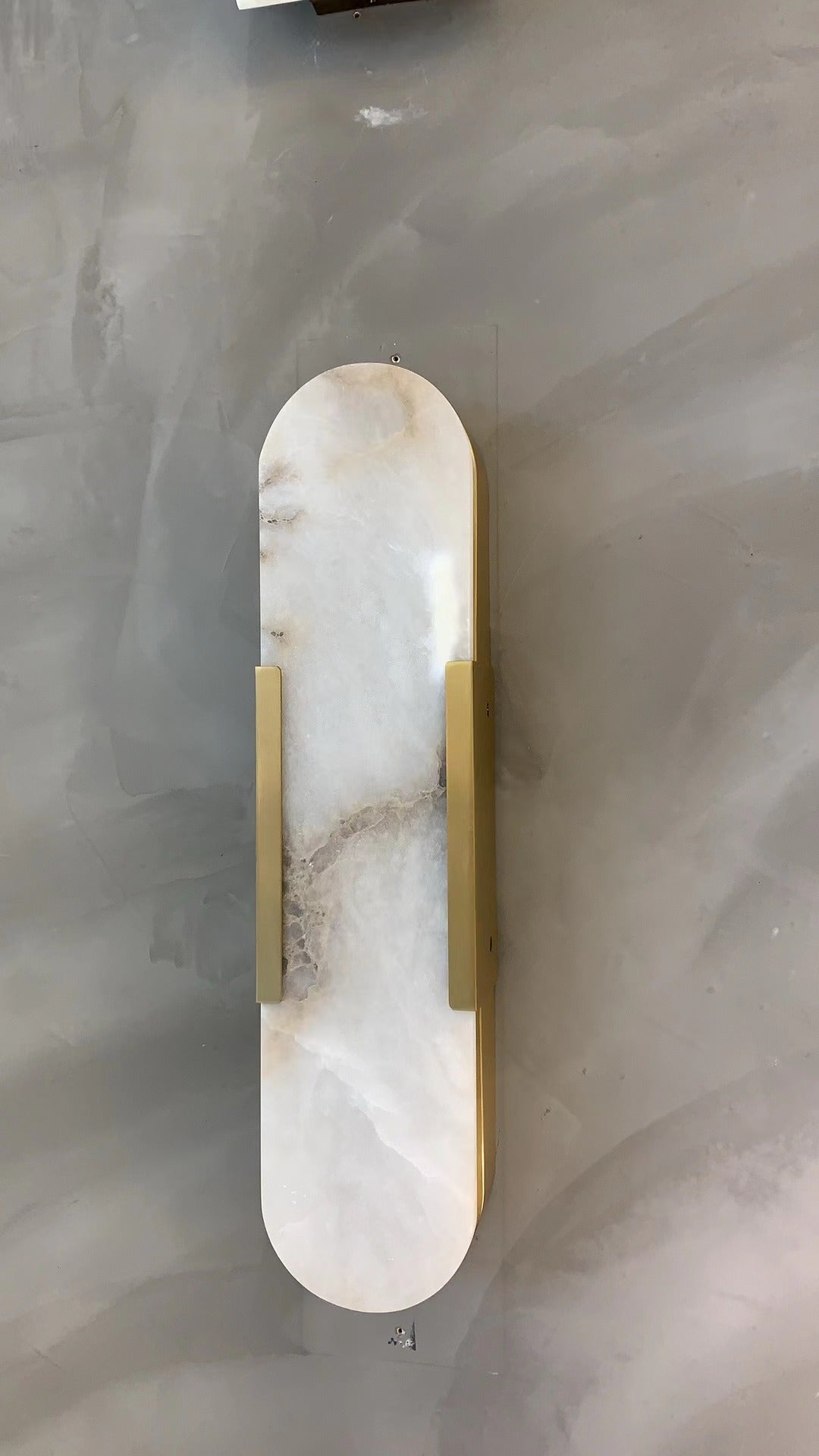 modern marble wall fixture with subtle texture and contemporary silhouette