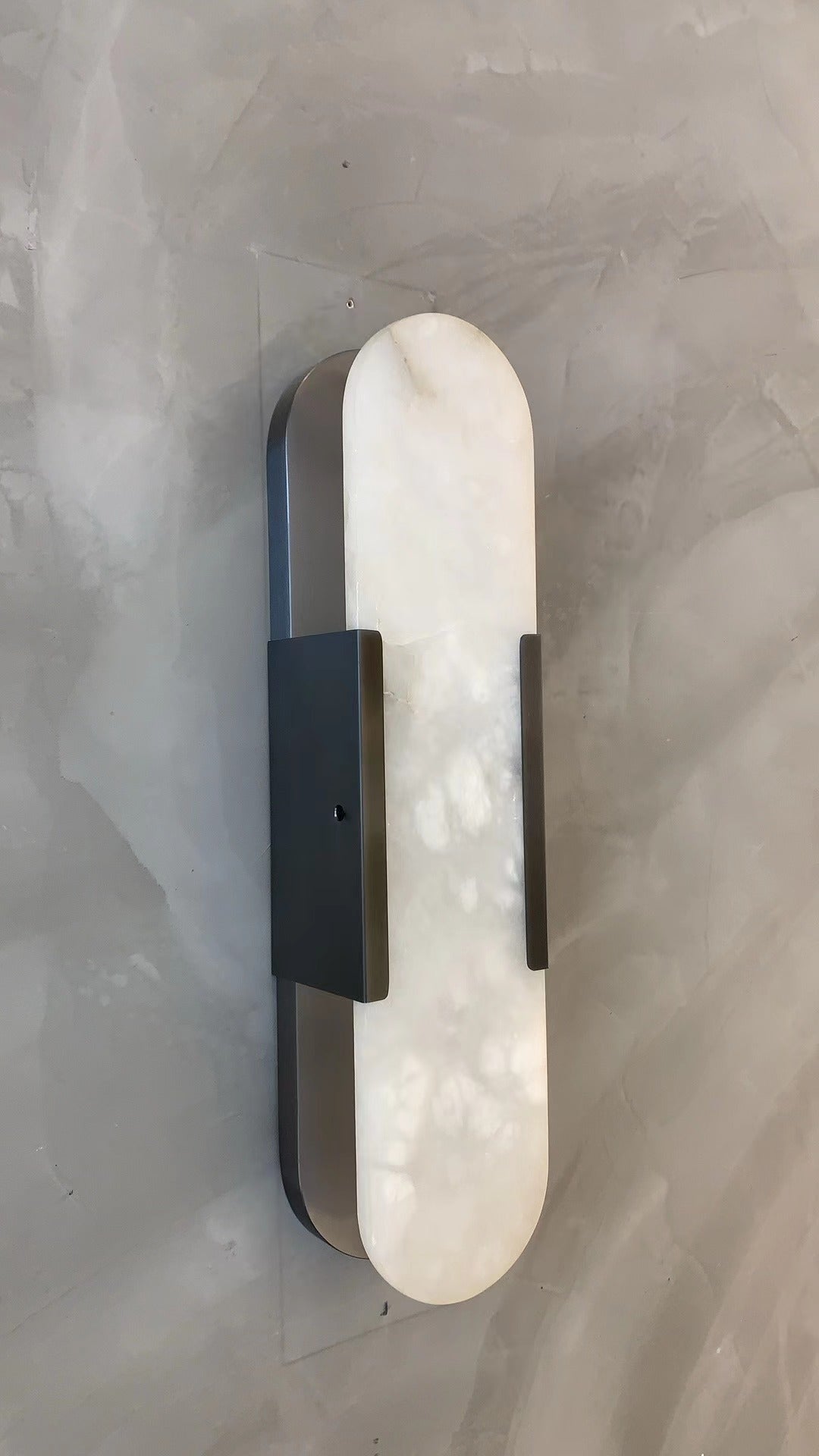 minimalist marble wall light casting ambient glow in contemporary interior