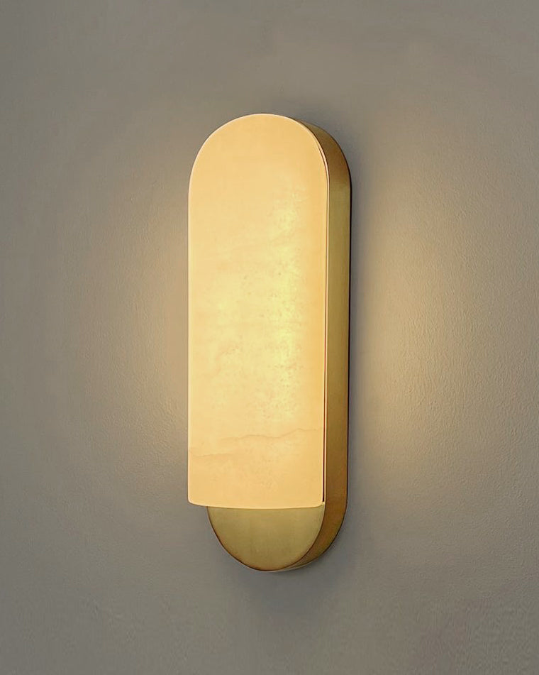 Angled view of Formello marble wall light emitting warm ambient glow