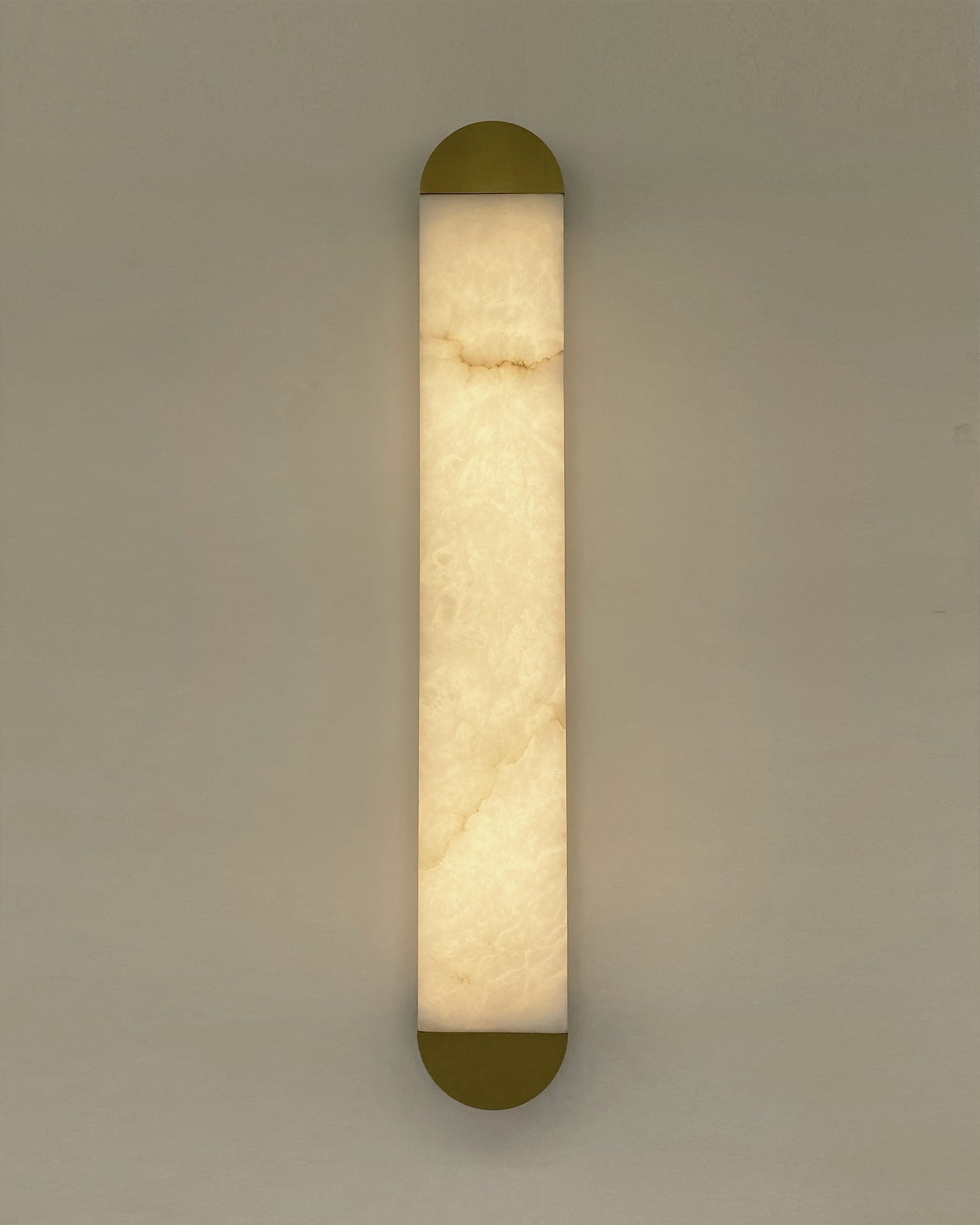 Close up of natural marble veining illuminated within sculptural wall light