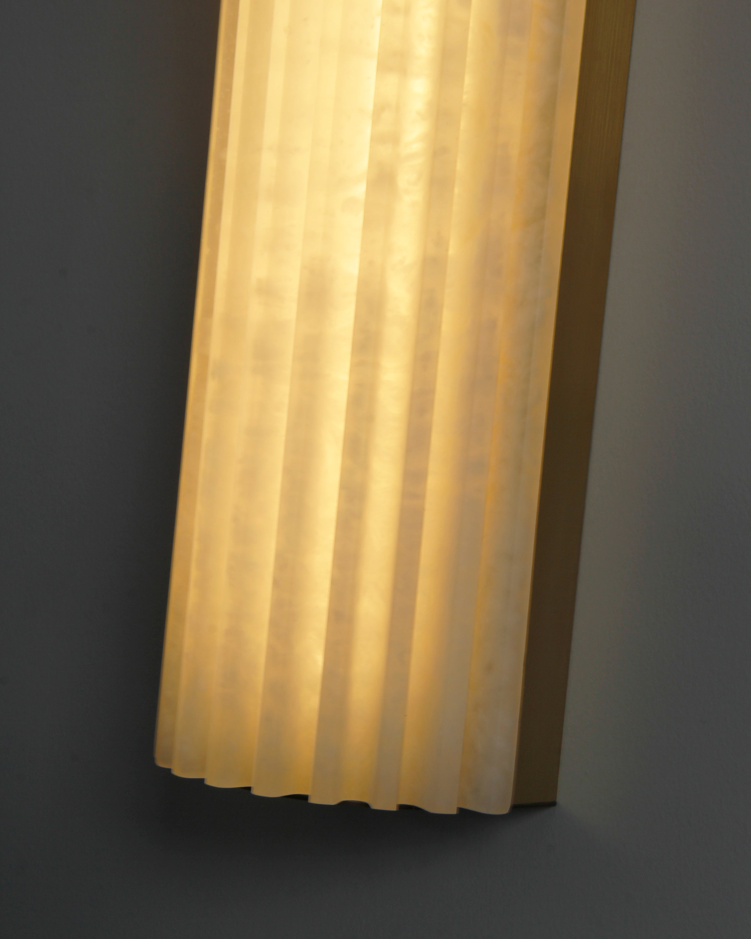 Close up of carved fluted marble texture with warm internal lighting