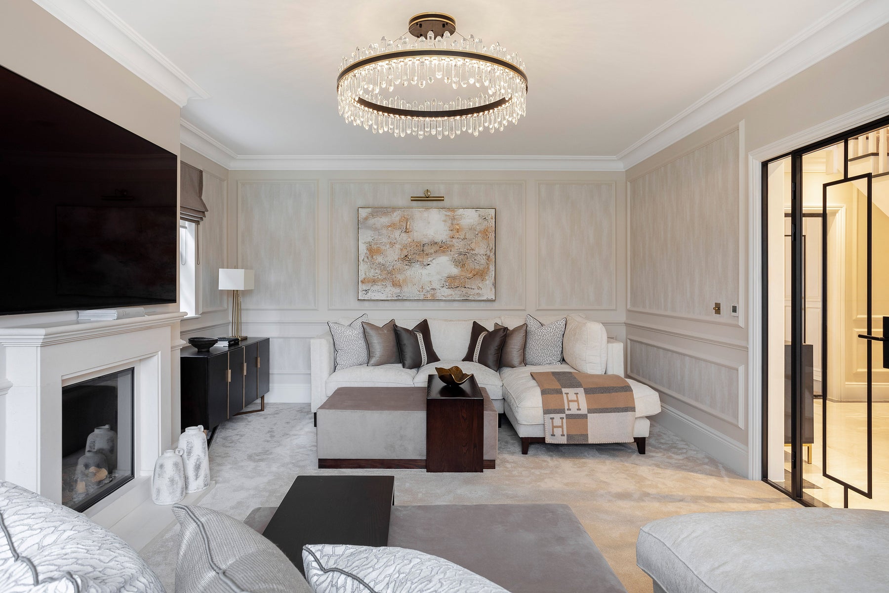 Luxury bedroom interior with a VORELLI circular chandelier above a refined bed setting