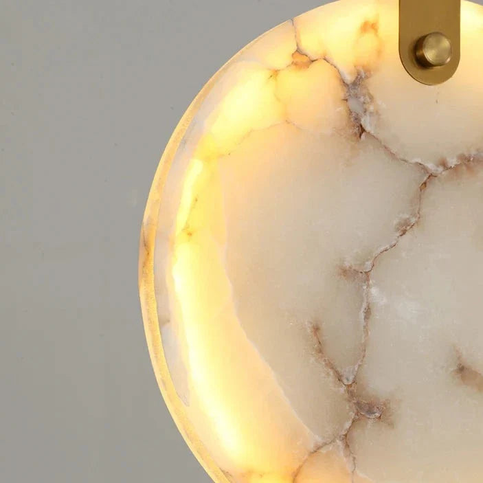 Close-up of VORELLI® Calacatta Marble Pendant with warm backlighting, showcasing natural veining and soft glow.