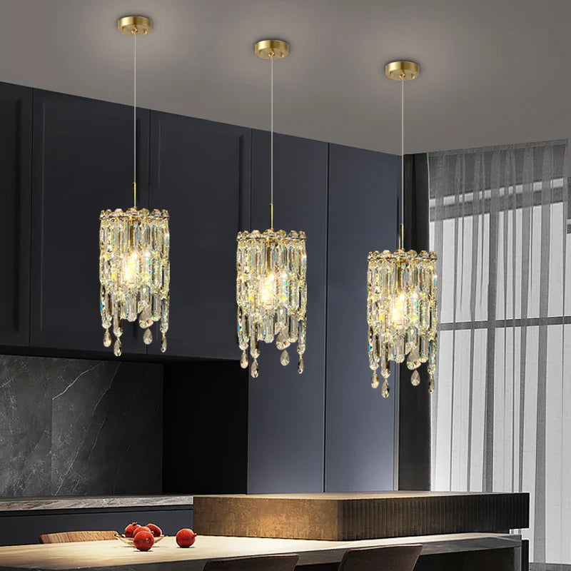Three Abruzzi crystal pendant lights hanging over a modern kitchen island in UAE home