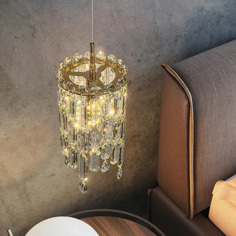 Gold Abruzzi crystal pendant light casting warm glow against textured wall