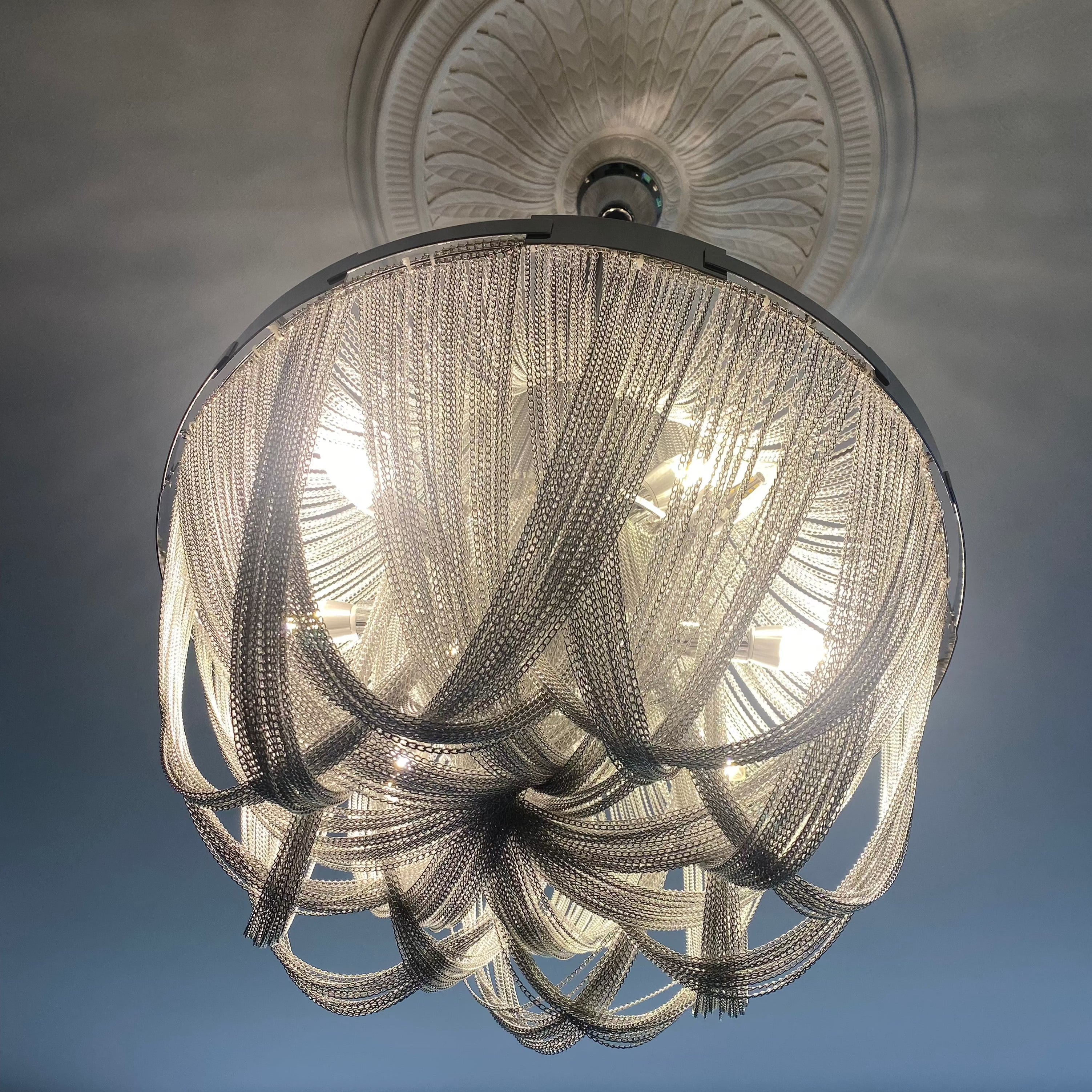 Close view of sculptural cascading metal chains on Adlington chandelier