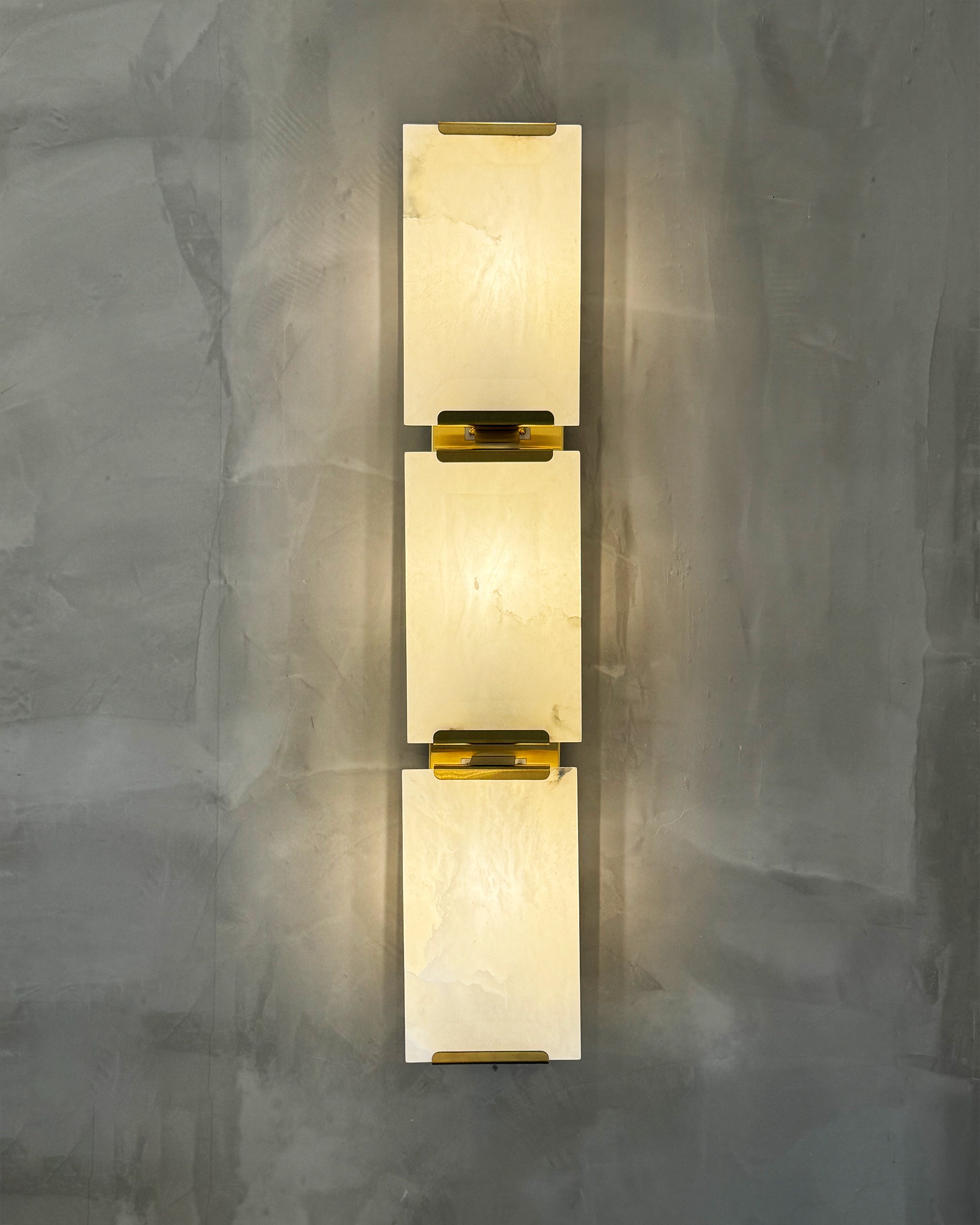 Close up of brass accent detail on Angel Marble Wall Light II