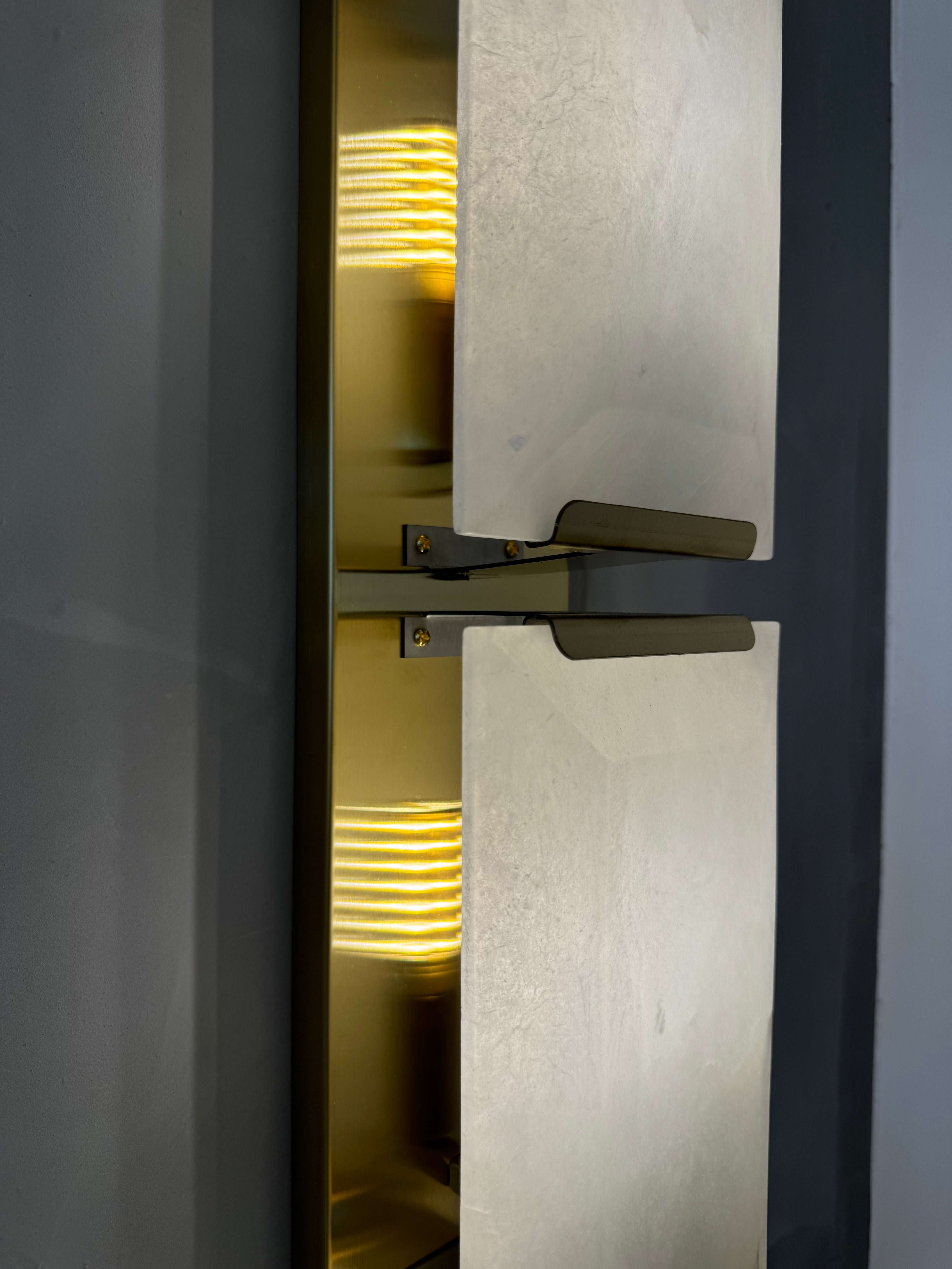 Side profile of Angel Marble Wall Light II highlighting layered stone and glow
