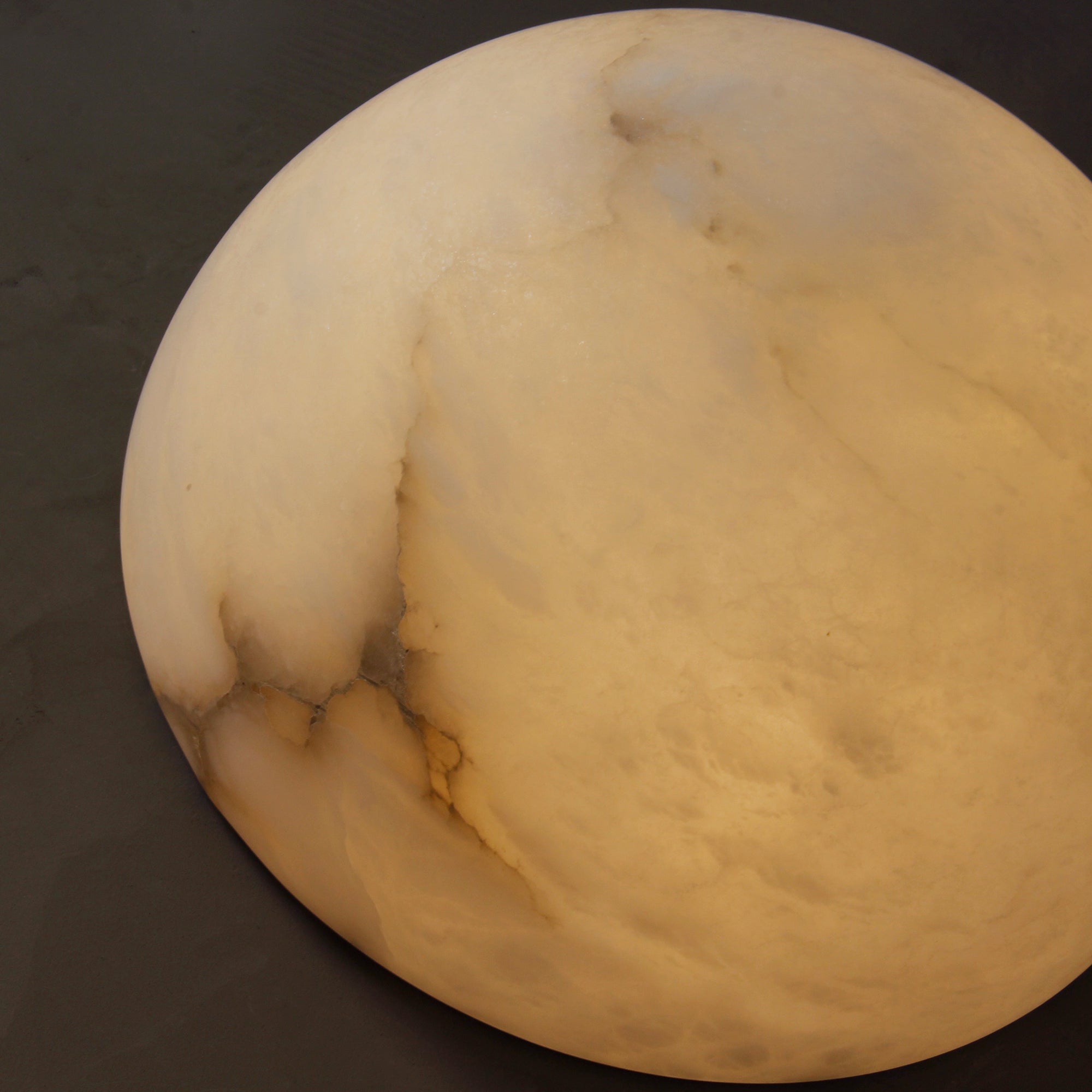 Close up of Arona natural marble wall light surface detail