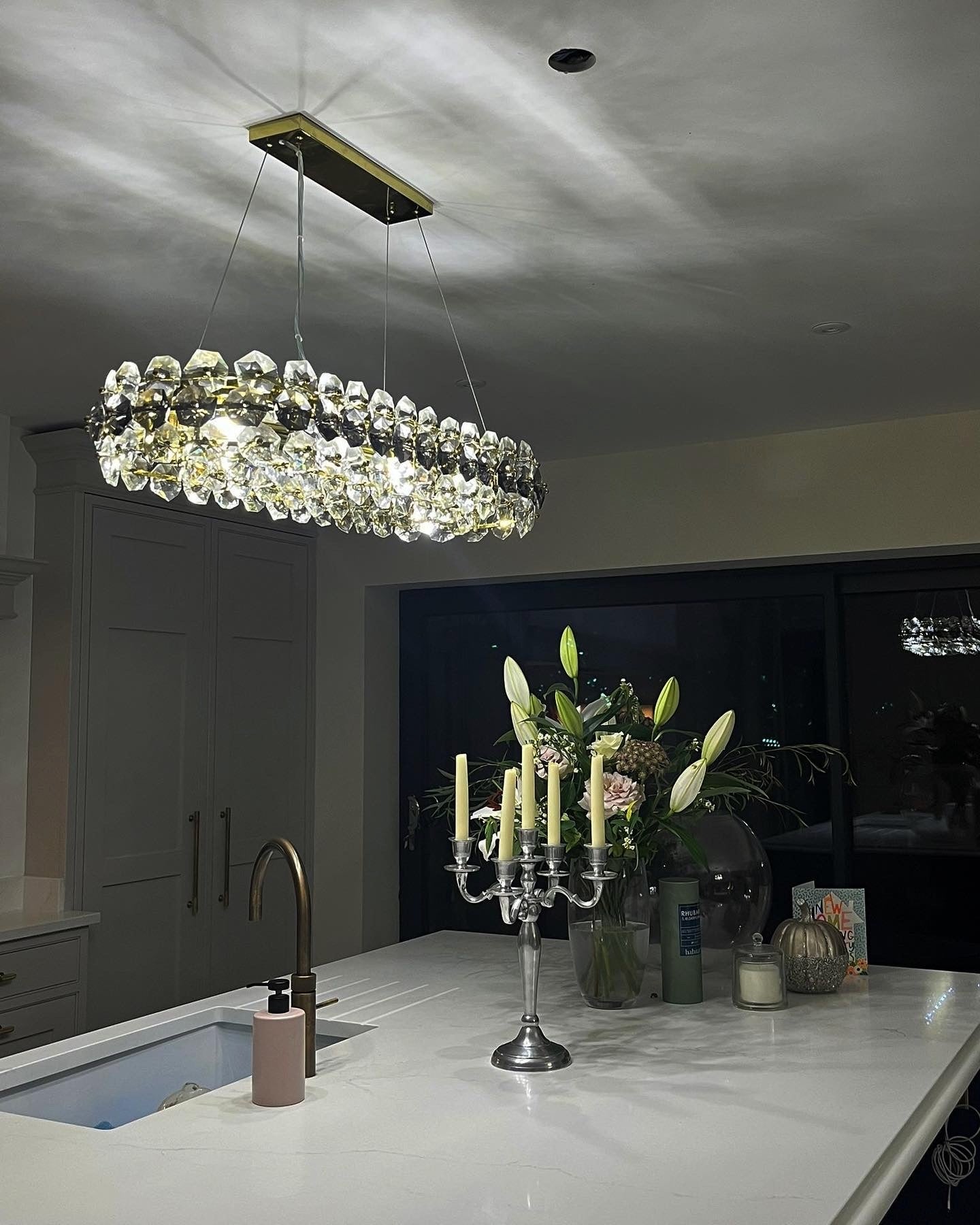Astoria rectangular chandelier illuminated in evening setting