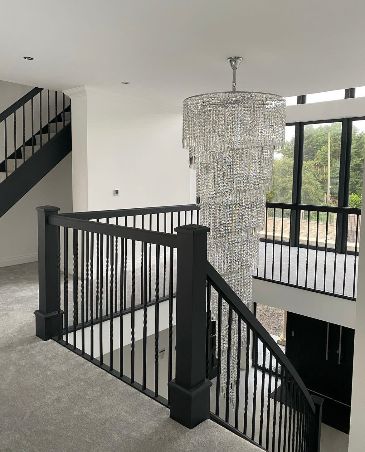 Full height Basiglio spiral crystal chandelier in grand staircase