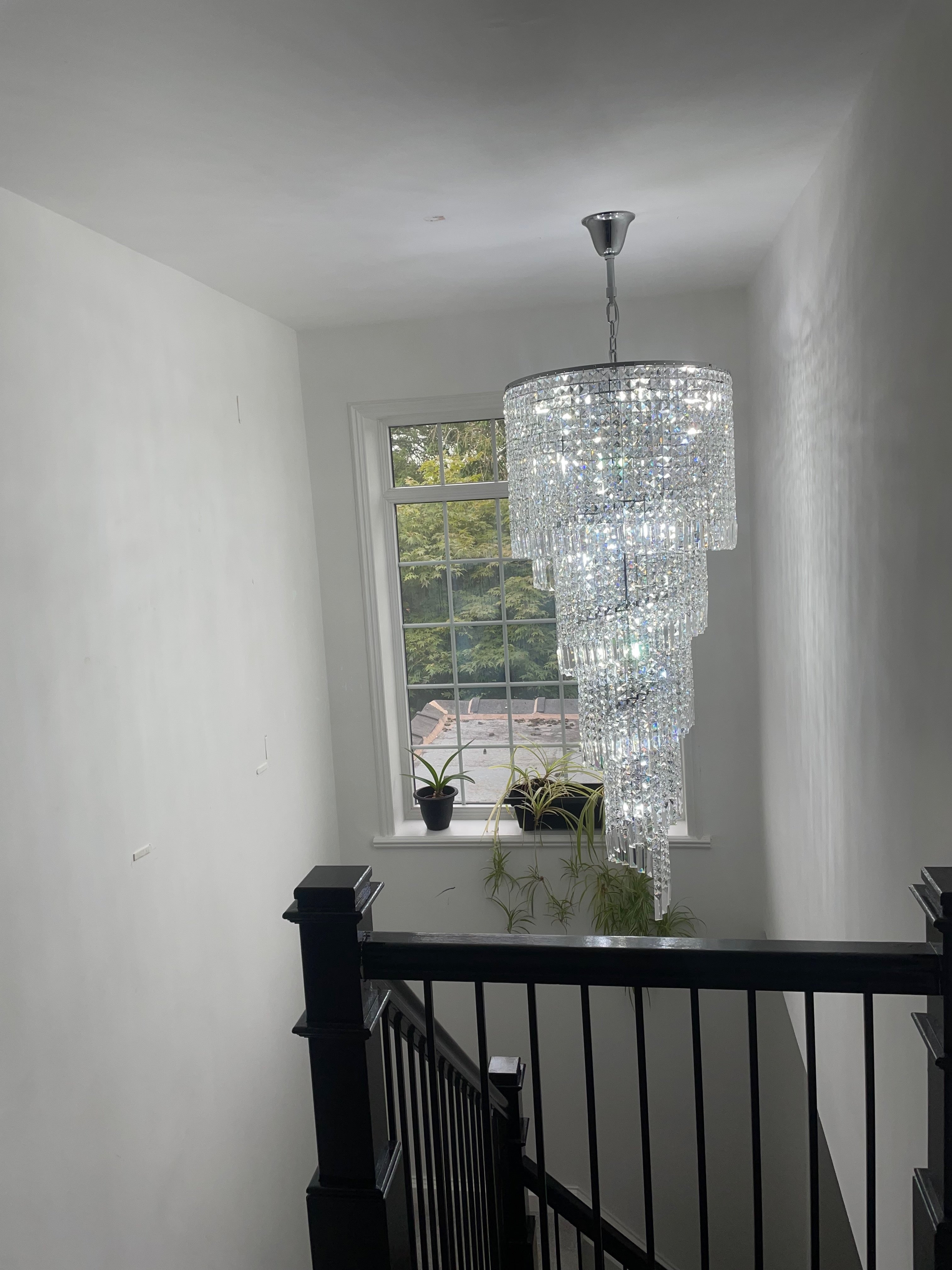 Full height Basiglio spiral crystal chandelier in grand staircase