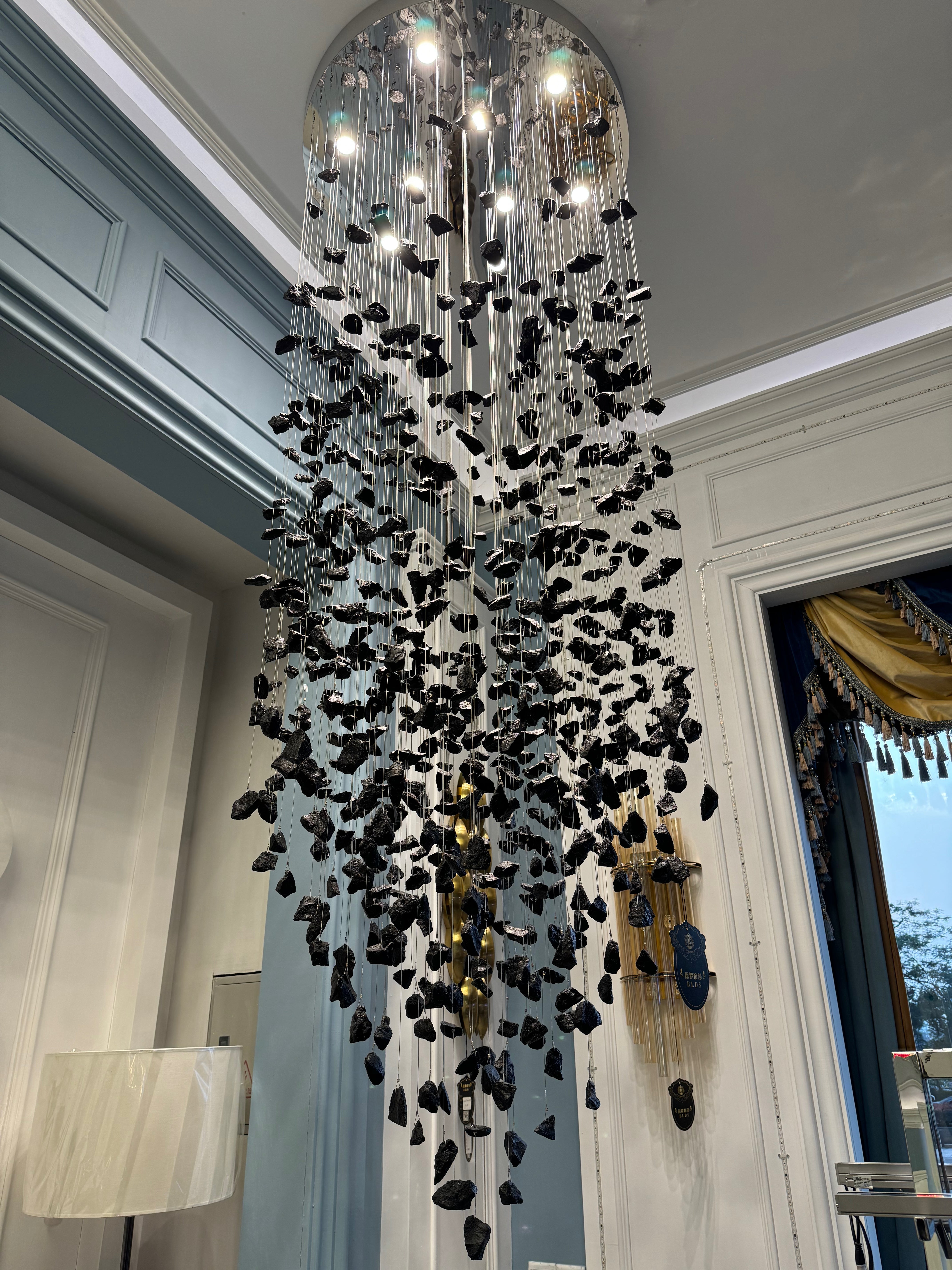 Basilicia crystal chandelier in double height luxury interior