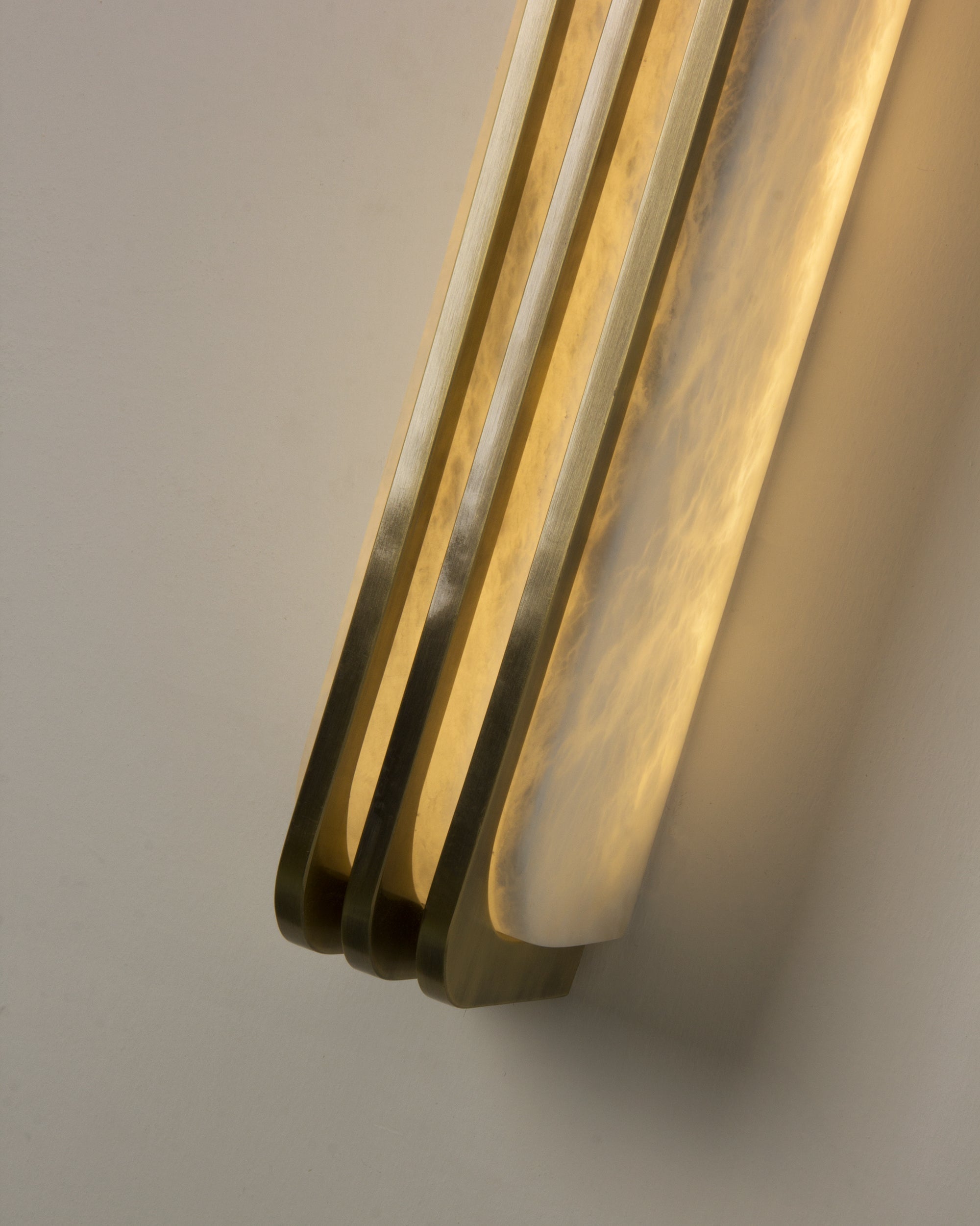 Close-up of layered gold trim on Bellagio marble wall light