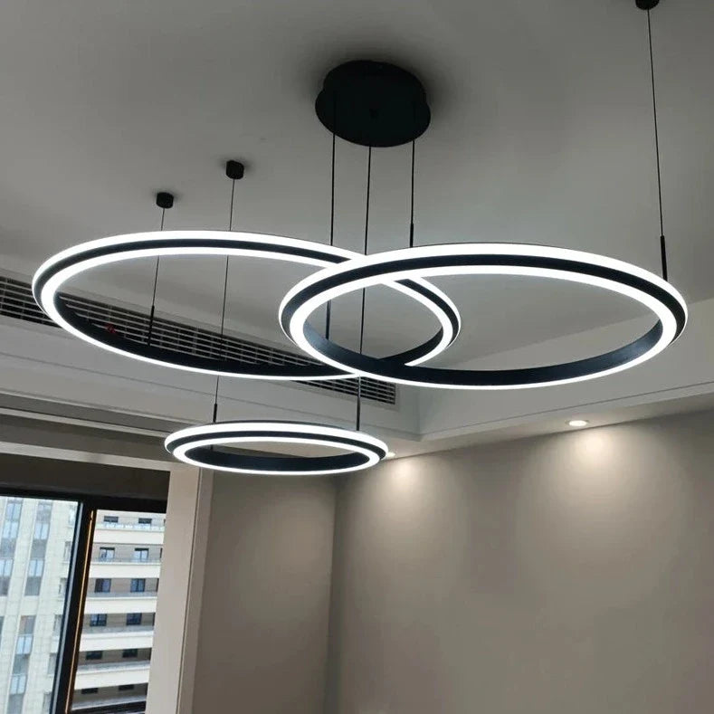 Bellezza Trio suspended LED ring chandelier in double height interior space