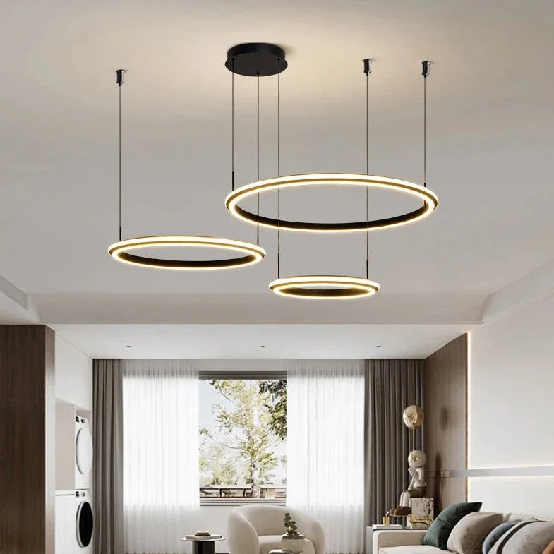 Bellezza Trio modern circular LED chandelier installed in contemporary living room