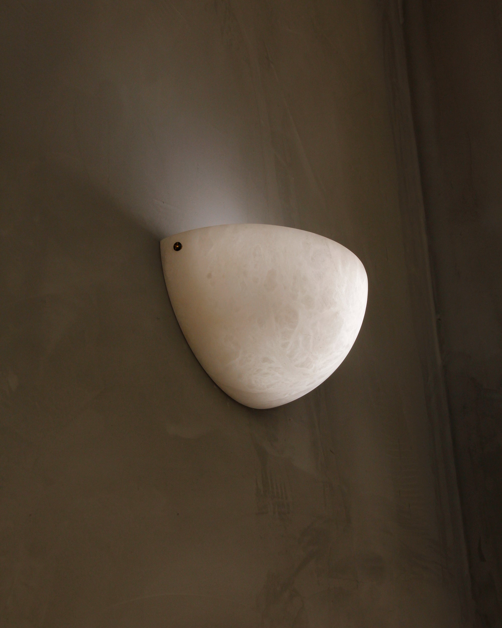 Belluno marble wall light installed in modern luxury interior setting