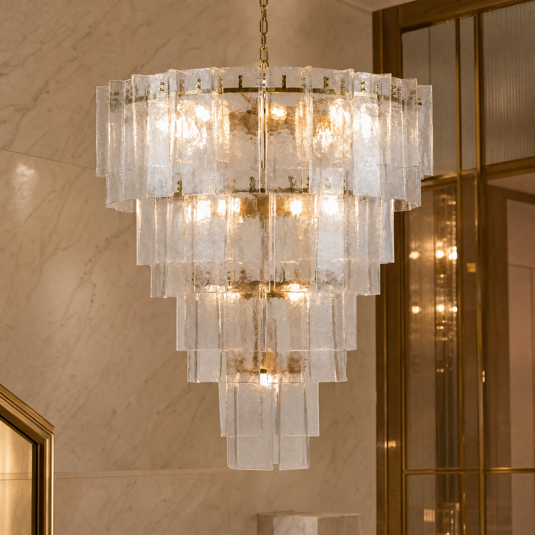 Luxury staircase chandelier in double height entrance hall by VORELLI