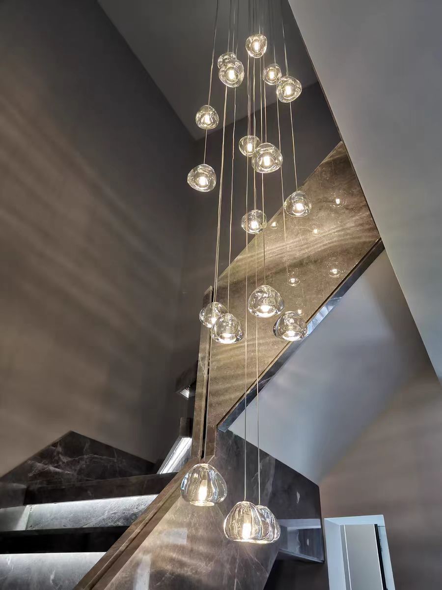 Biella staircase chandelier creating vertical ambient glow