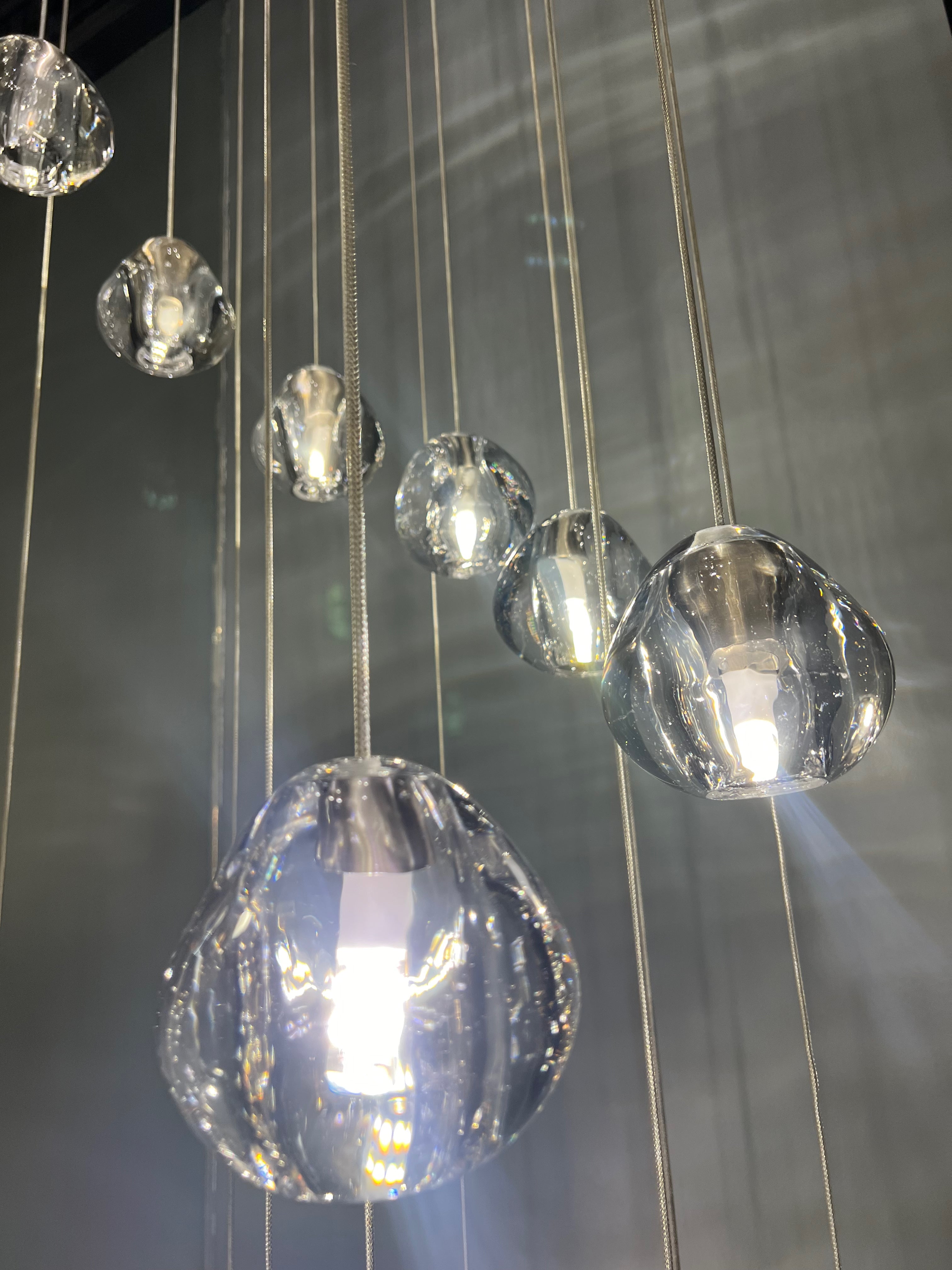 Cascading cluster arrangement of glass pendants on Biella chandelier