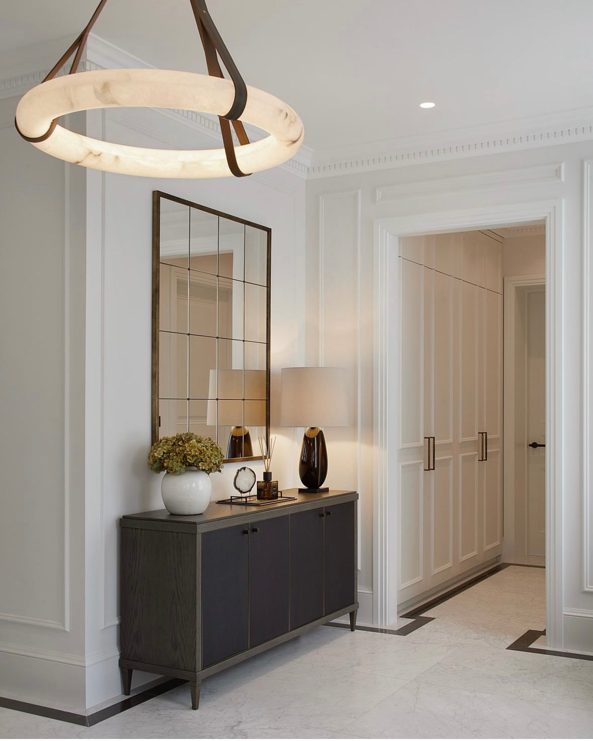 Botticino marble circular chandelier installed in modern luxury interior