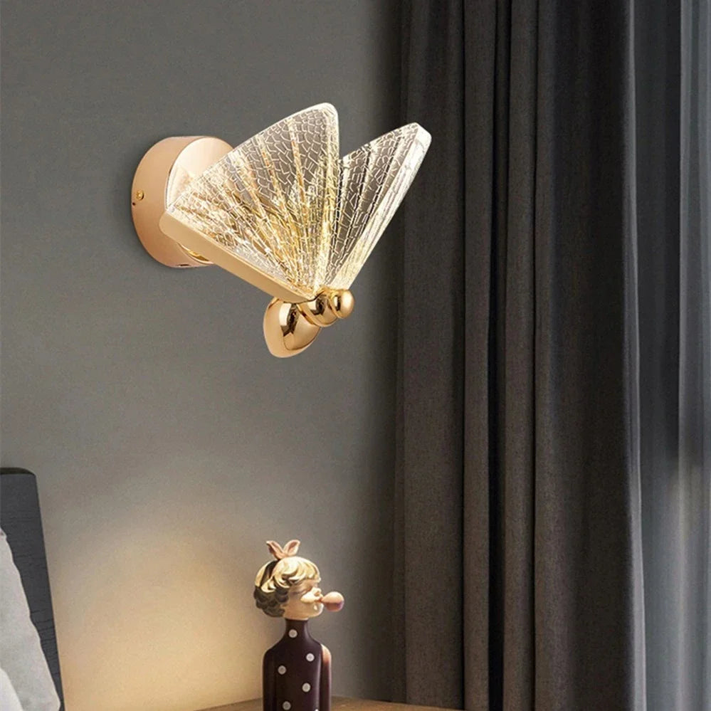 Side view of decorative butterfly wall light glowing softly