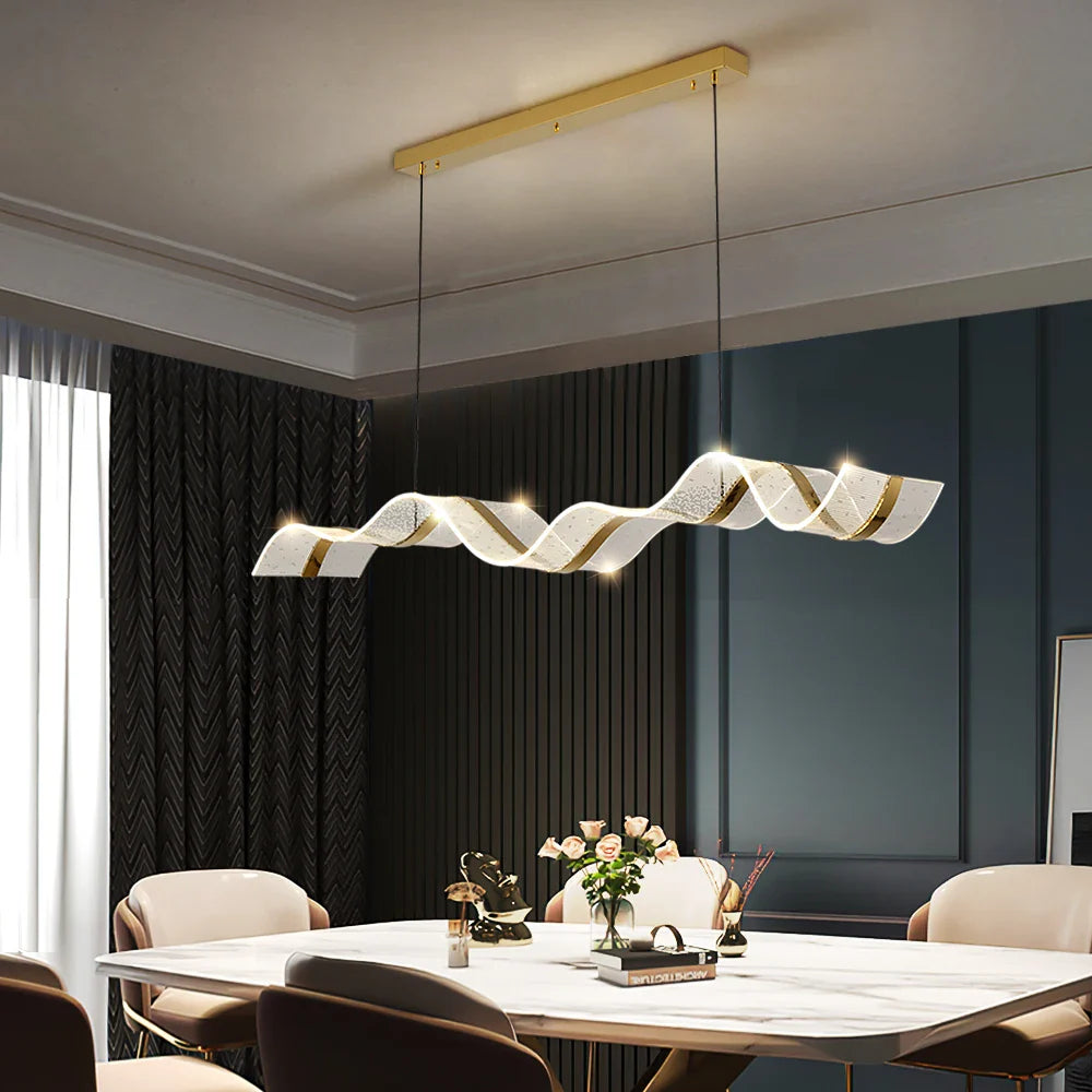 Capitano curved chandelier suspended above dining table