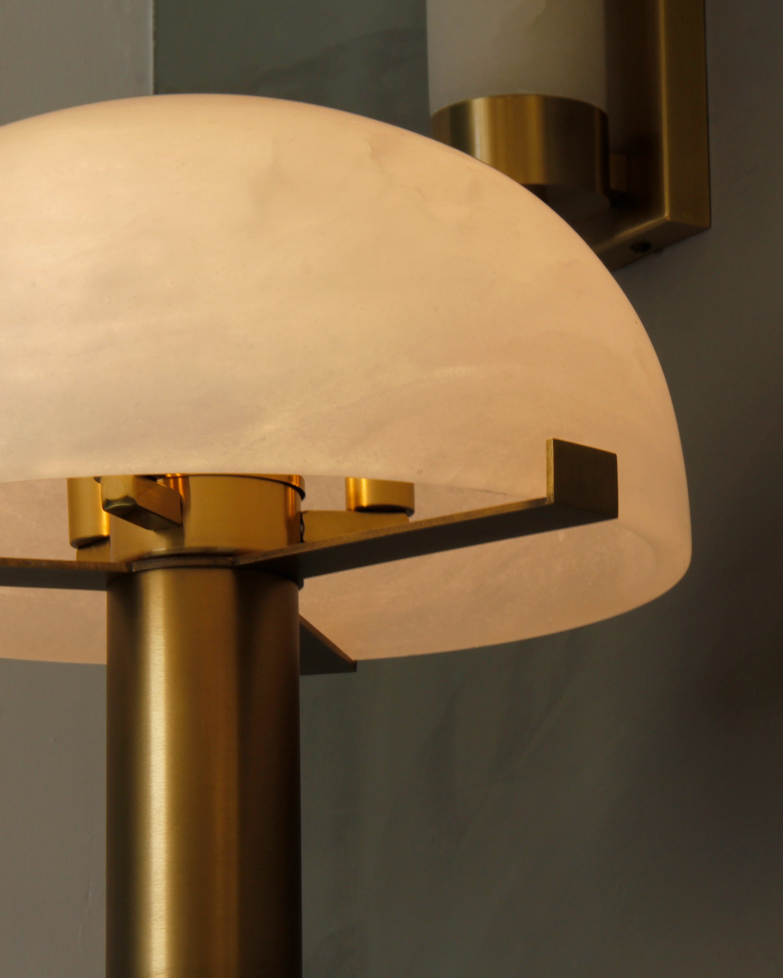 Close-up of marble dome shade revealing natural veining and refined texture