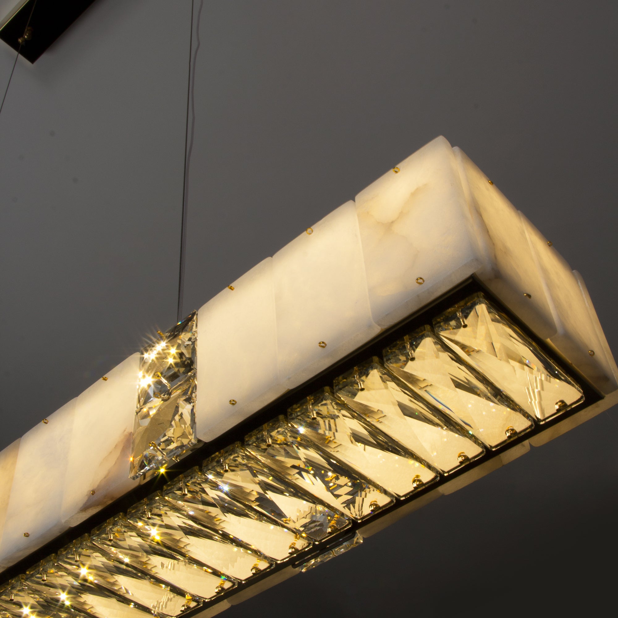 Helios Marble Rectangular Chandelier II showcasing faceted diamond cut crystal detailing beneath natural marble panels