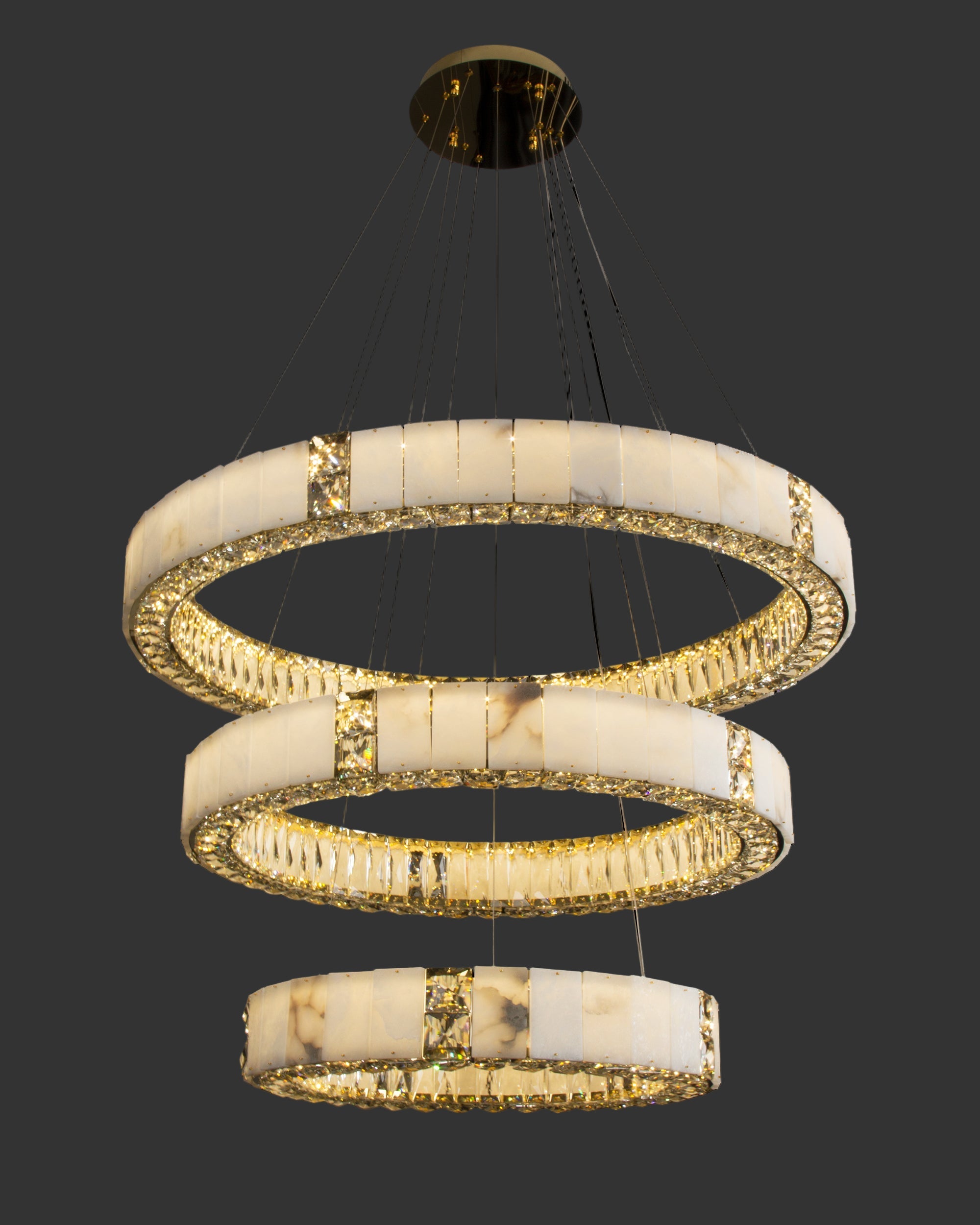 Helios Marble Trio Circular Chandelier featuring three luminous marble rings with faceted crystal detailing in a sculptural suspended form
