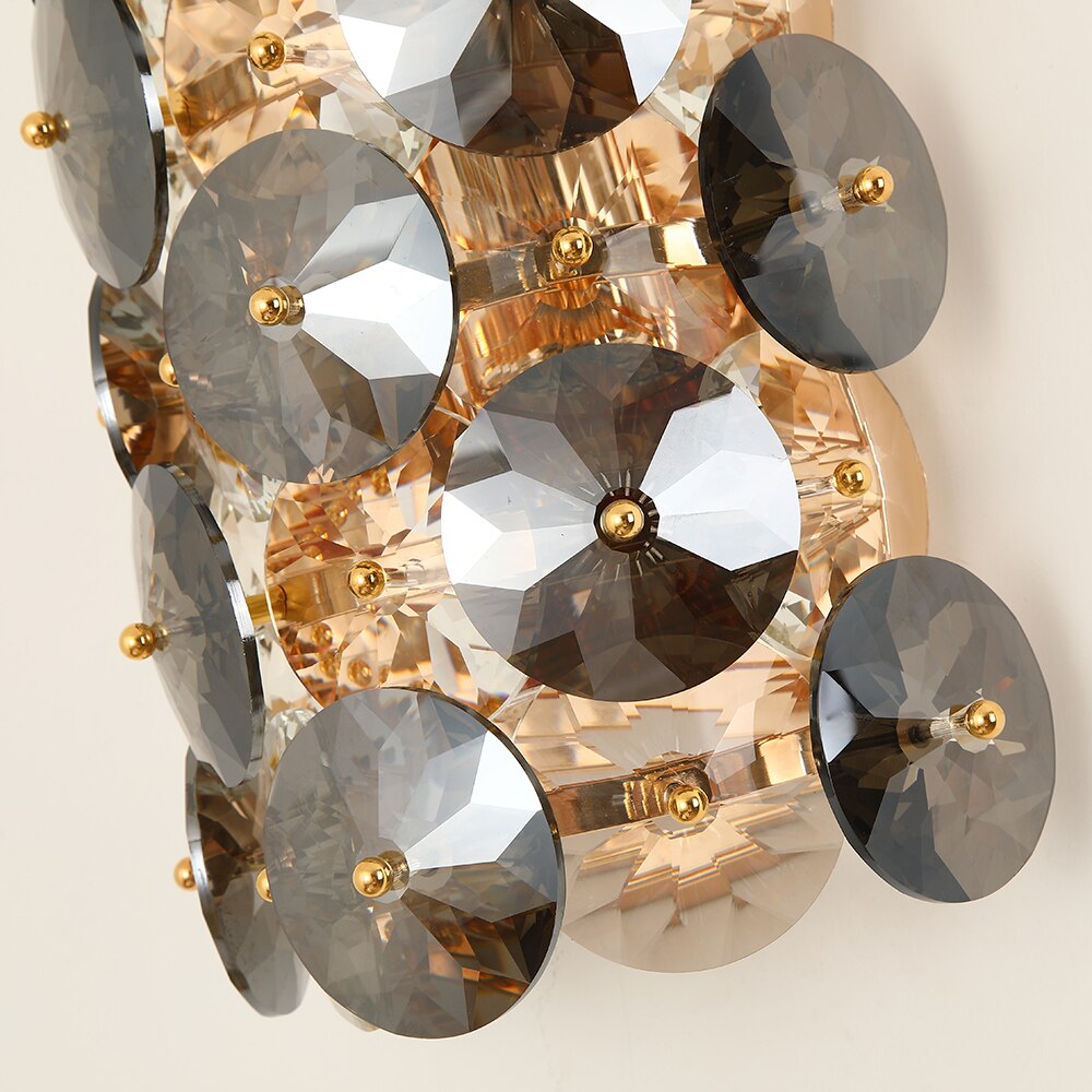 Close-up of clear and smoky grey diamond cut crystal discs on the Lorenzo wall light