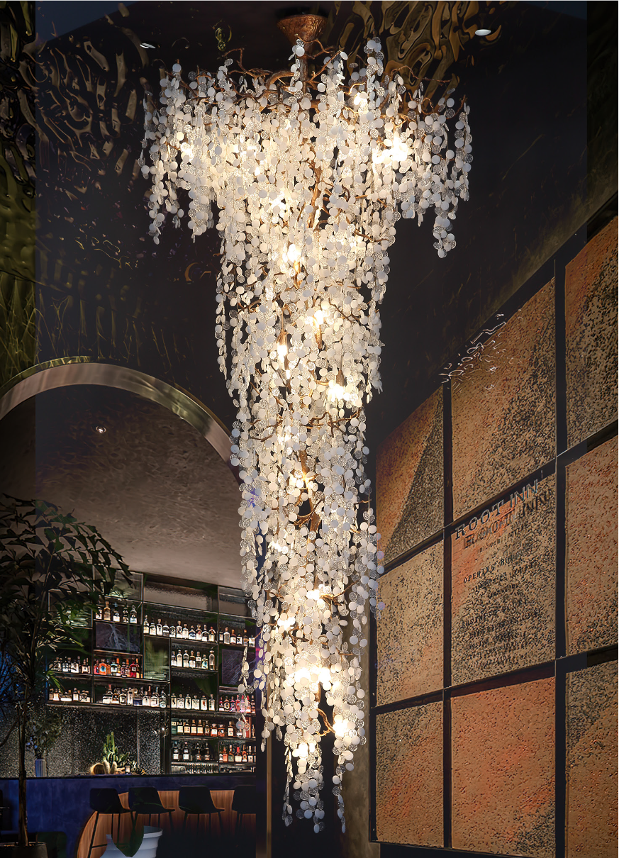 Linear staircase chandelier with cascading glass discs in a luxury interior setting