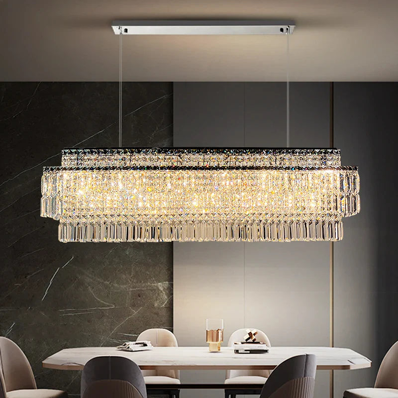 Luxury rectangular chandelier centered above modern dining table UAE