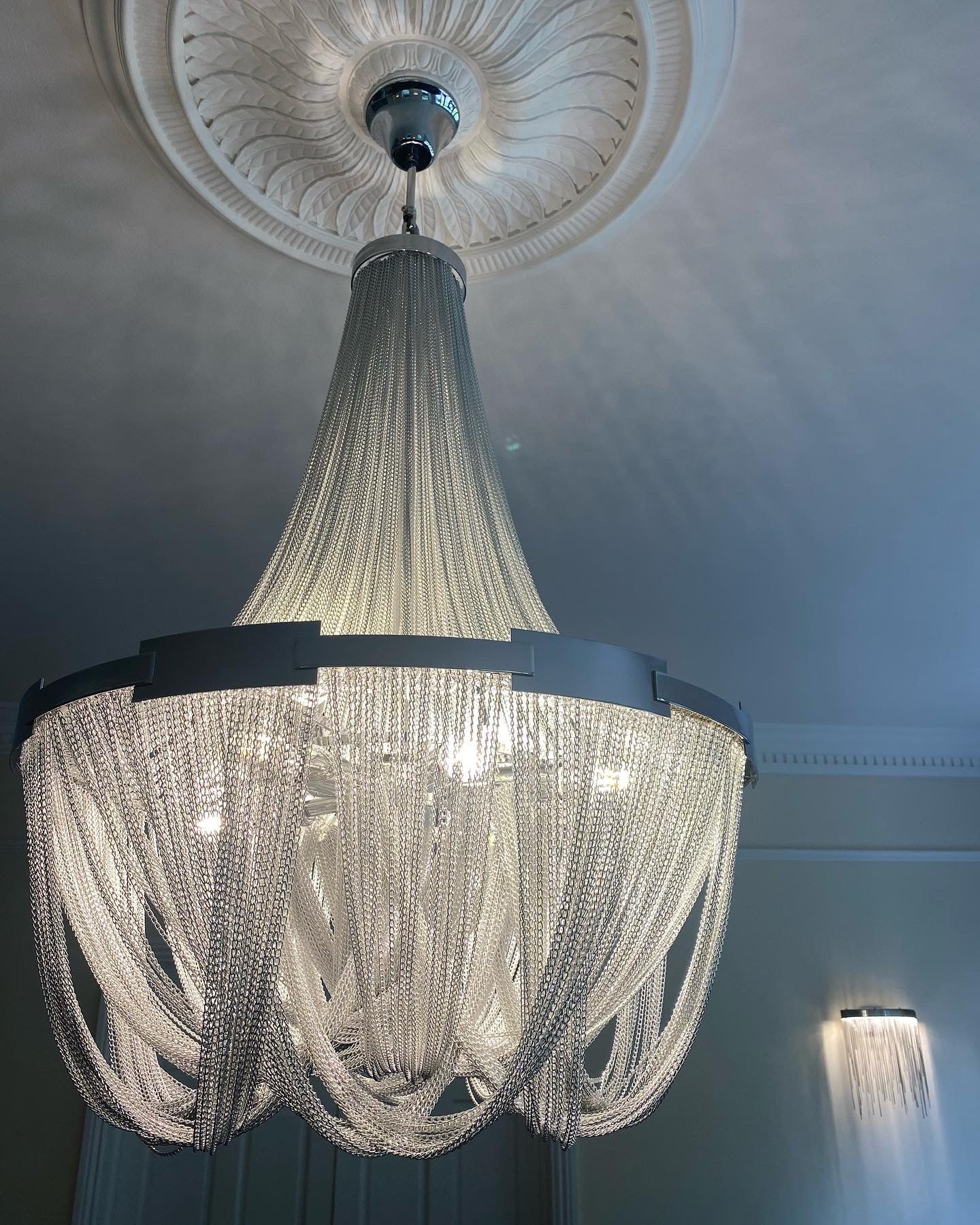 Luxury cascading chain staircase chandelier installed in Dubai villa