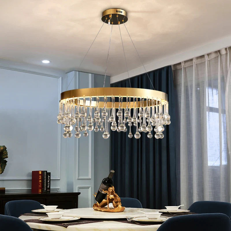 Mancini circular ring chandelier with hanging crystal droplets above a modern dining table