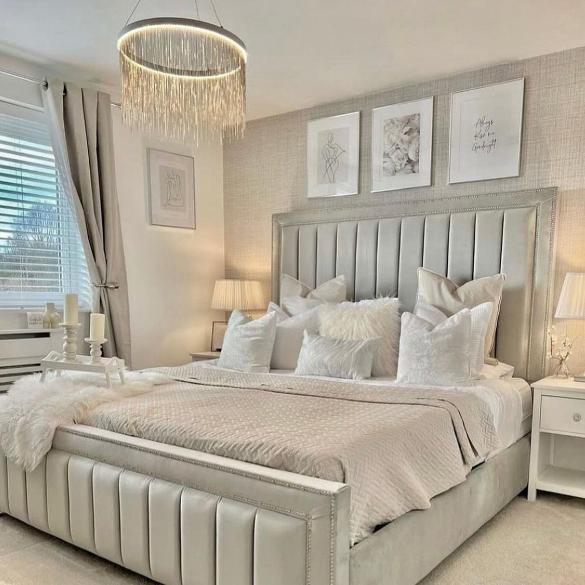 Modern circular chandelier installed above bed in Dubai bedroom