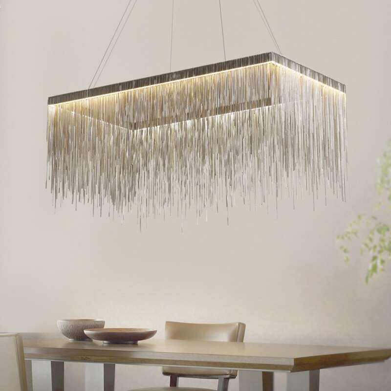Modern rectangular chandelier above dining table in Dubai home