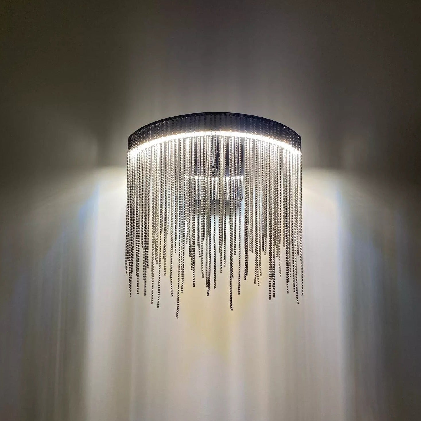Modern cascading chain wall light installed in UAE hallway