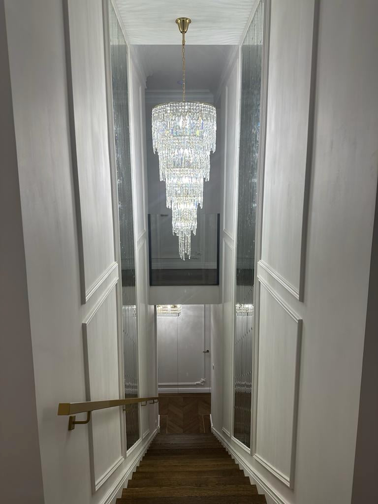 Modern spiral staircase chandelier in contemporary UAE home